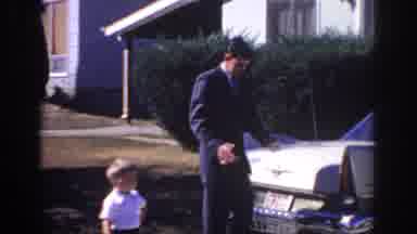 Sacramento California USA (1966): Dad Comes Home From Work To Greet Son And Wife