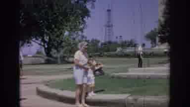 Oklahoma USA (1967): Woman, Man, And Small Child Sightseeing As Woman Looks Into