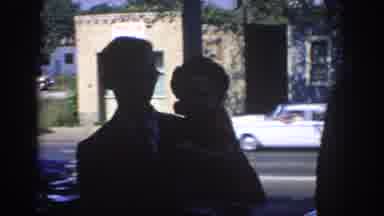 Oklahoma USA (1967): Man Holding Child Walks Along Street Adorned With Beautiful
