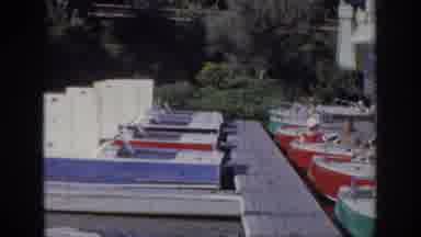 Oklahoma USA (1967): Kid Driving A Boat On A Old Port With His Father At A Sunny