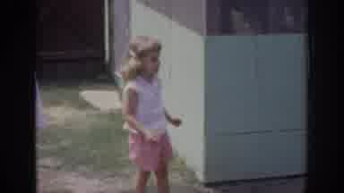 Oklahoma USA (1967): Little Girl Being Passed A Ball By An Adult In Front Yard