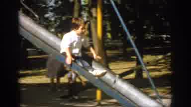Oklahoma USA (1967): Kids On Slide And Dad Sitting In Lawn Chair Holding Football