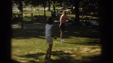 Oklahoma USA (1967): Girl And Adult Man Playing Baseball At A Family Picnic
