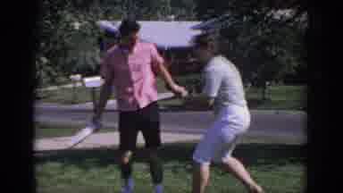 Oklahoma USA (1967): Man And Woman Playfully Having A Tug Of War Fight On Suburban