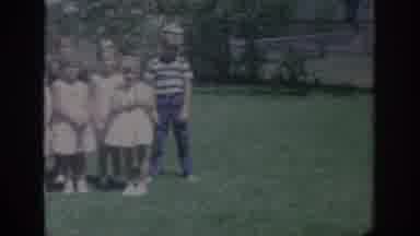 Oklahoma USA (1967): A Group Of Sixteen Children Standing In A Yard Smiling