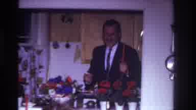 Rockaway Beach New York USA (1967): A Man Holding A Candle On The Background Party