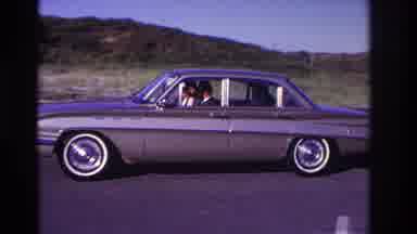 Rockaway Beach New York USA (1967): Vehicle Driving Slowly In A Parking Lot