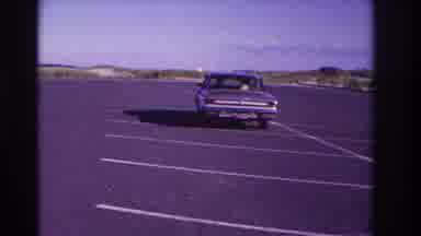 Rockaway Beach New York USA (1967): Car Leaving The Parking Lot With Three People