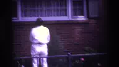 Rockaway Beach New York USA (1967): Man Looking For Someone In A Window Then A Cat