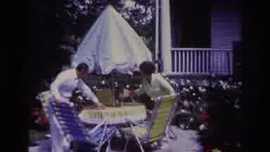 Rockaway Beach New York USA (1967): A Cat On A Patio Table Being Handled By A