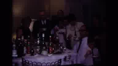 Rockaway Beach New York USA (1967): Man Shares Drinks With Family As They Gather