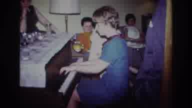Rockaway Beach New York USA (1967): Woman Wearing Blue Dress Plays Piano At