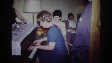 Rockaway Beach New York USA (1967): Woman Wearing Blue Dress Plays Piano At