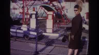 Rockaway Beach New York USA (1967): Woman Accompanies Child On Toy In Amusement