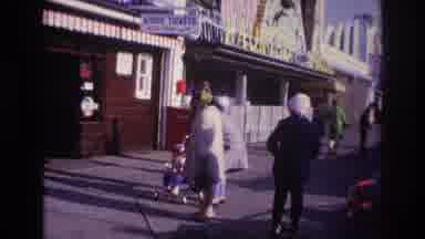 Rockaway Beach New York USA (1967): Woman Helps Child Being Pushed Down Busy