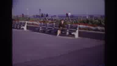 Rockaway Beach New York USA (1967): Camera Zooms In On A Woman Sitting Outside On