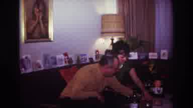 Rockaway Beach New York USA (1967): Couple Opening Container Sitting On Table