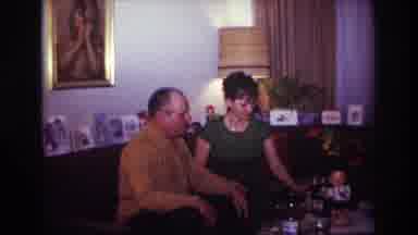 Rockaway Beach New York USA (1967): Woman Giving A Man A Bottle In The Middle Of A