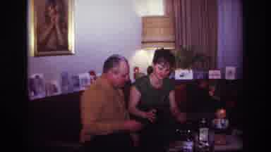 Rockaway Beach New York USA (1967): Woman Serves Drink To A Man