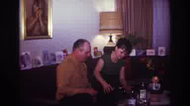 Rockaway Beach New York USA (1967): A Woman Pours A Man A Drink At A Coffee Table