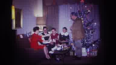 Rockaway Beach New York USA (1967): Family Exchanges Christmas Cards While Sitting