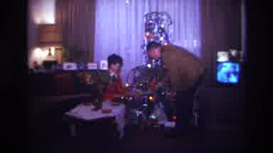 Rockaway Beach New York USA (1967): An Older Man Hands A Christmas Present To A