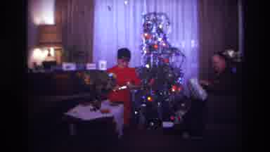 Rockaway Beach New York USA (1967): A Family Opening Christmas Presents In Front