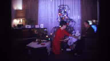 Rockaway Beach New York USA (1967): Woman In Red And Man Exchange Christmas Gifts