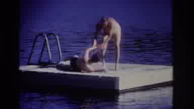 Ocean City New Jersey USA (1968): Person Helps Another Person Stand Up On A Dock