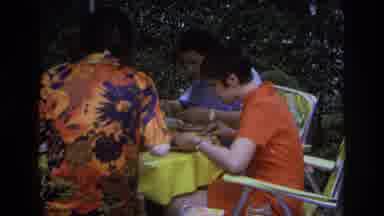 Ocean City New Jersey USA (1968): Three Individuals Sitting Down Eating With