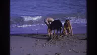 Ocean City New Jersey USA (1968): Two Kids Play With Dog In The Sand By The Sea