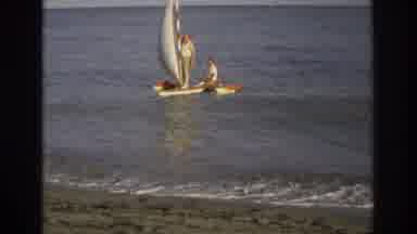 Ocean City New Jersey USA (1968): Two Men On A Small Sailboat On A Body Of Water