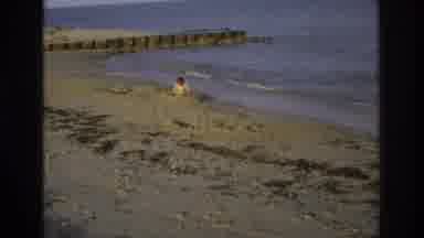 Ocean City New Jersey USA (1968): Child And Dog Play In Sand At Beach In Daylight