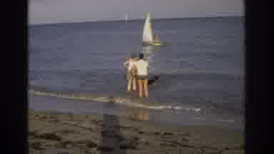 Ocean City New Jersey USA (1968): Two Men And A Dog Wade In The Shallows Of A