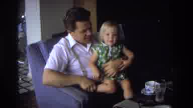 Ocean City New Jersey USA (1968): A Man Holding A Little Girl, Giving Her A Bottle