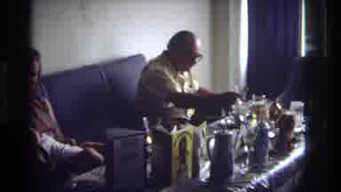 Ocean City New Jersey USA (1968): A Man Sitting On A Couch Leans Forward To Put
