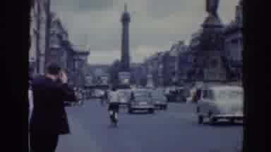 Dublin Ireland (1961): Old Film, Busy Road, Tower In Back Of Busy Town, Pan To