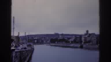 Dublin Ireland (1961): A Waterway With Rock Walls Runs Through An Urban Area On An