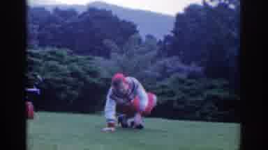 Dublin Ireland (1961): A Person In A Grassy Park Twists Their Ankle And Knees To