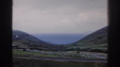Ireland (1961): Train Tracks Running Through Rolling Hills With A Body Of Water In