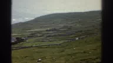 Ireland (1961): Landscape Of Hills With Grass And Rocks Running Into The Ocean