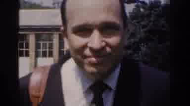 Ireland (1961): Man Walks Toward Camera People Walk On Sidewalks In Park