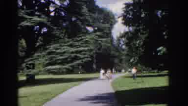 Ireland (1961): Mom Takes A Break After A Walk Through The Park With Family
