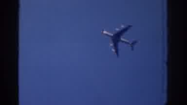 Ireland-1961: A Person Lying on Grass Watching an Airplane Fly Over