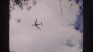 Ireland (1961): People Walking Past A Green House While A Plane Flies Above