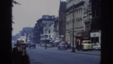 London England-1961: Vintage City Street with Classic Cars and Pedestrians