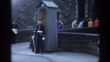 London England (1961): Guarding Building While People Walk Outside Looks Like