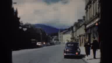 Scotland (1961): People Walking In An Old Small Town On A Summer Day With Cards