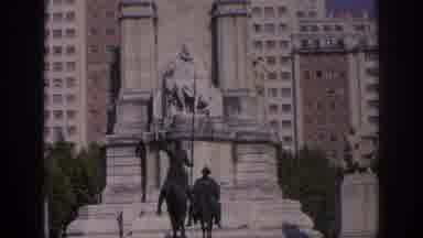 Spain (1966): Monuments Standing By Buildings Next To Each Other Large Windows