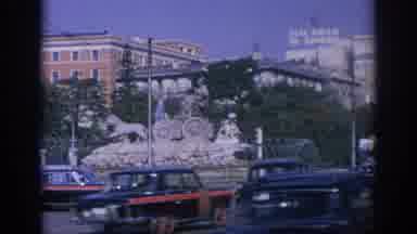 Spain (1966): Police Officer Directing Busy Traffic In Crowded City Showing Water